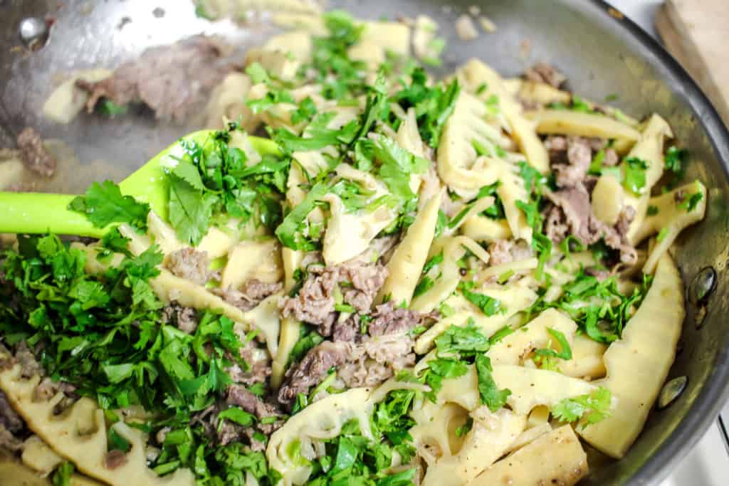 bamboo and beef stir fry in a stainless steel pan