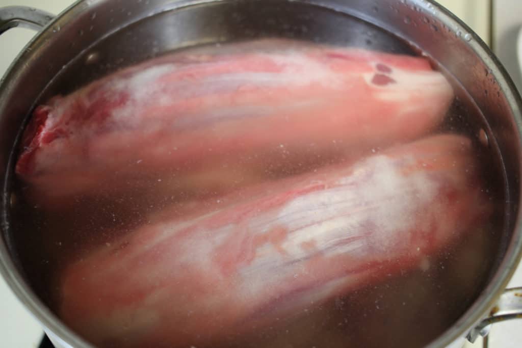 Beef shank and pork feet in water