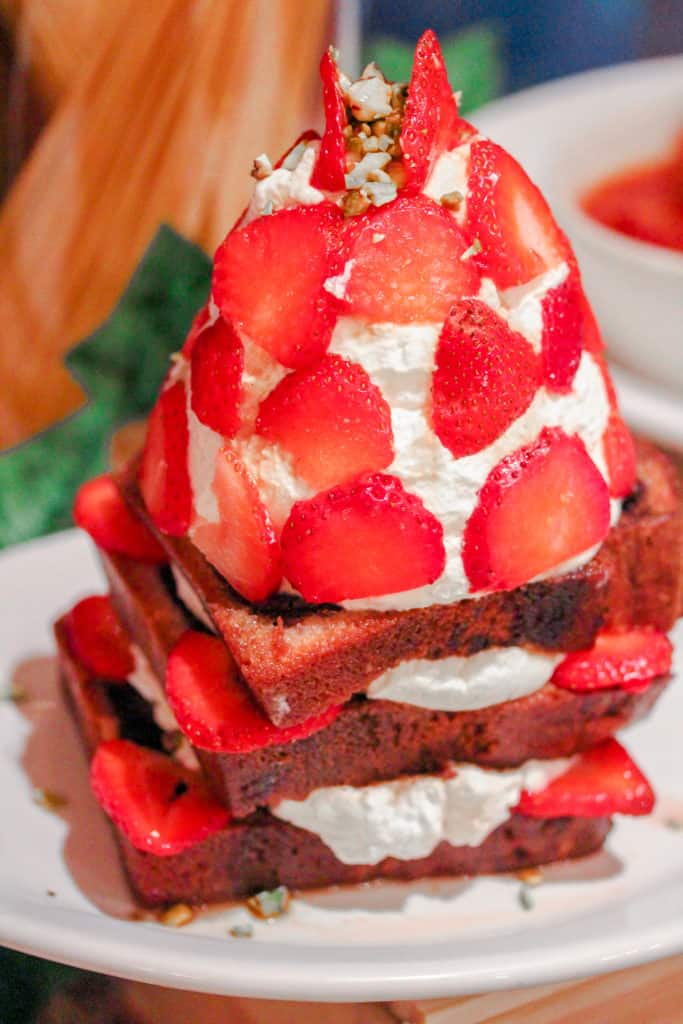 slices of pound cake topped with whipped cream and strawberries from carmine's