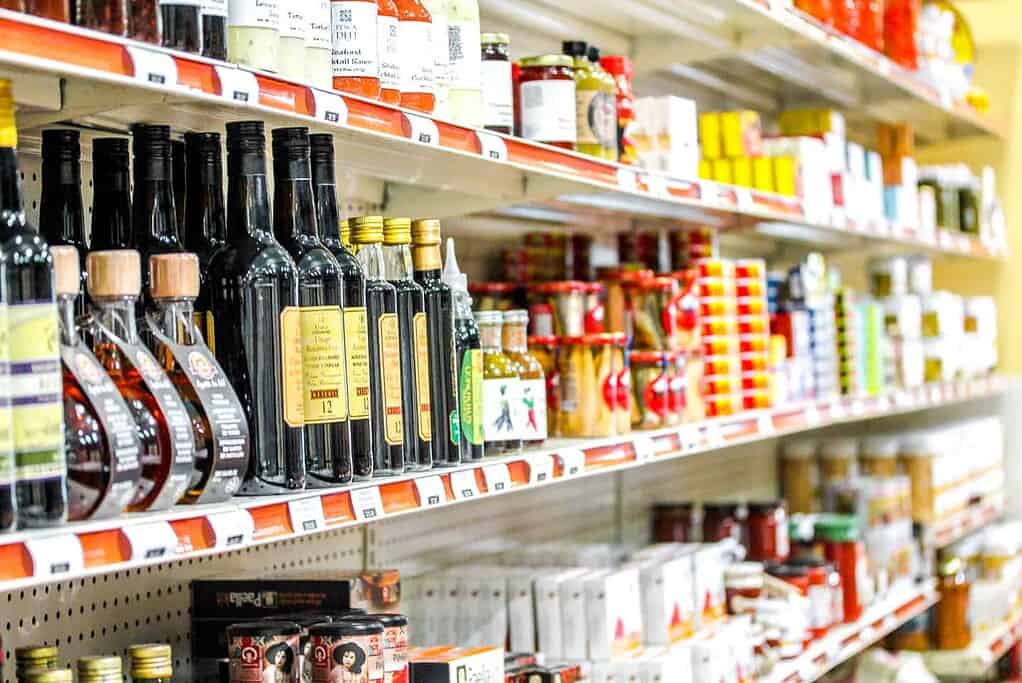 bottles of oils and vinegars on a shelf at Pescadeli