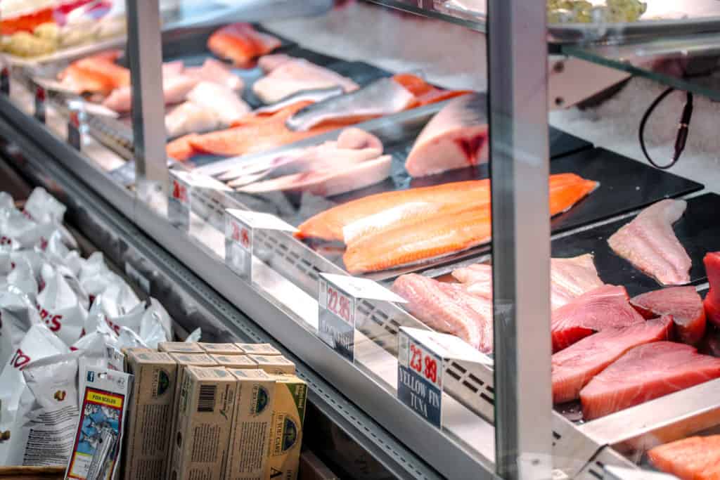 filets of different fishes behind a glass case at pescadeli