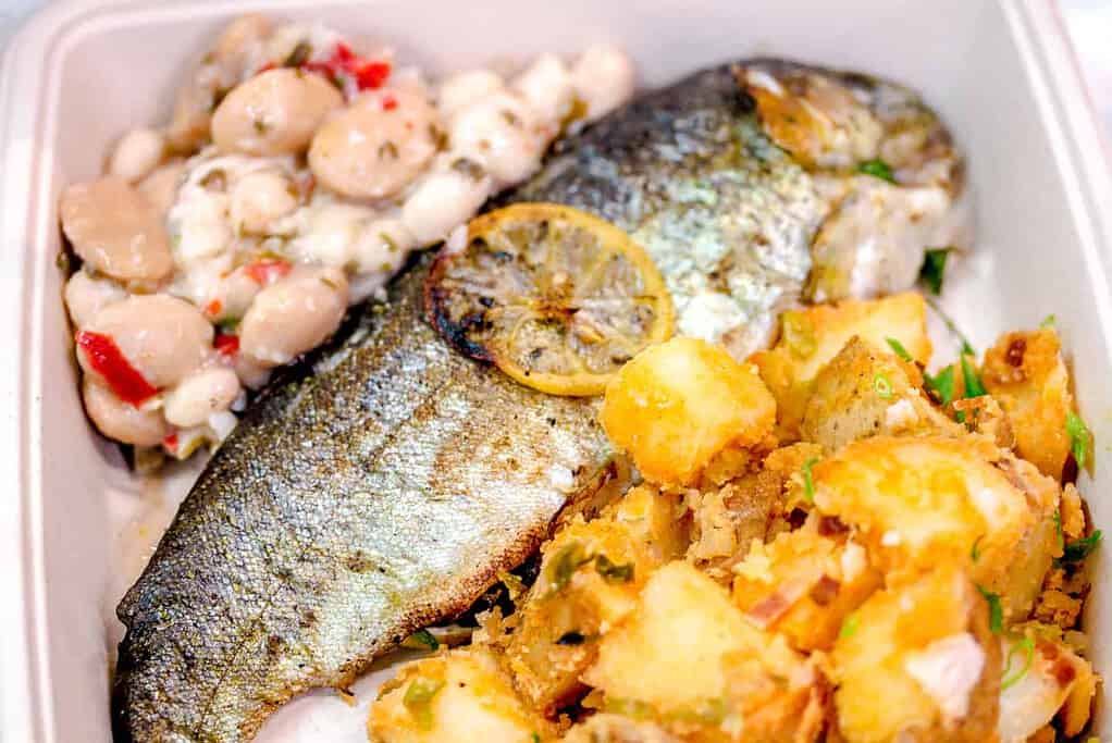 whole grilled fish, spicy potatoes and bean salad