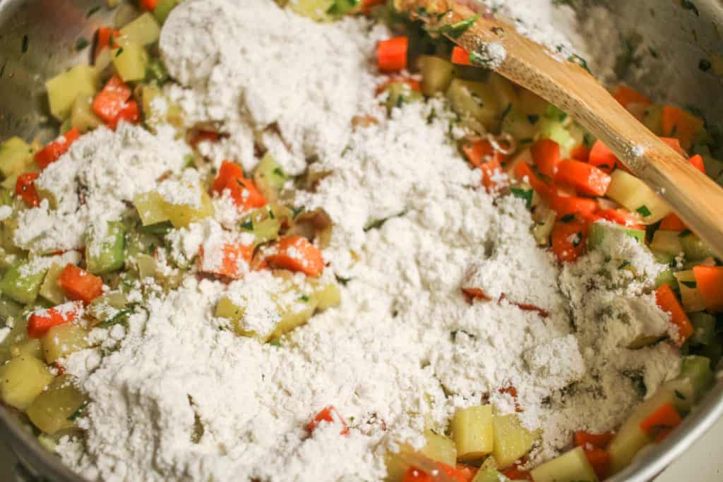 flour on top of vegetables for pot pie