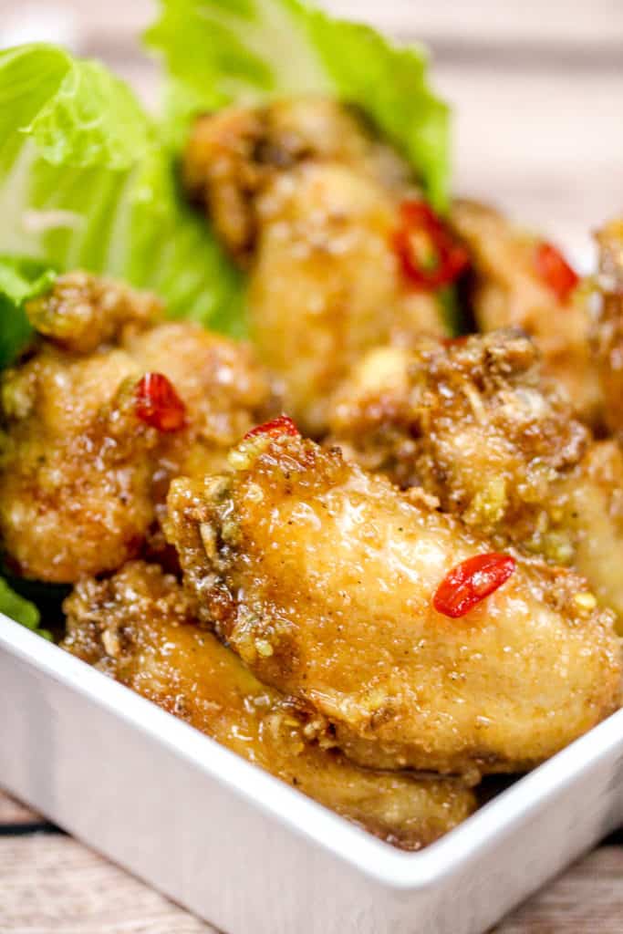 Chicken wings in a bowl with romaine lettuce