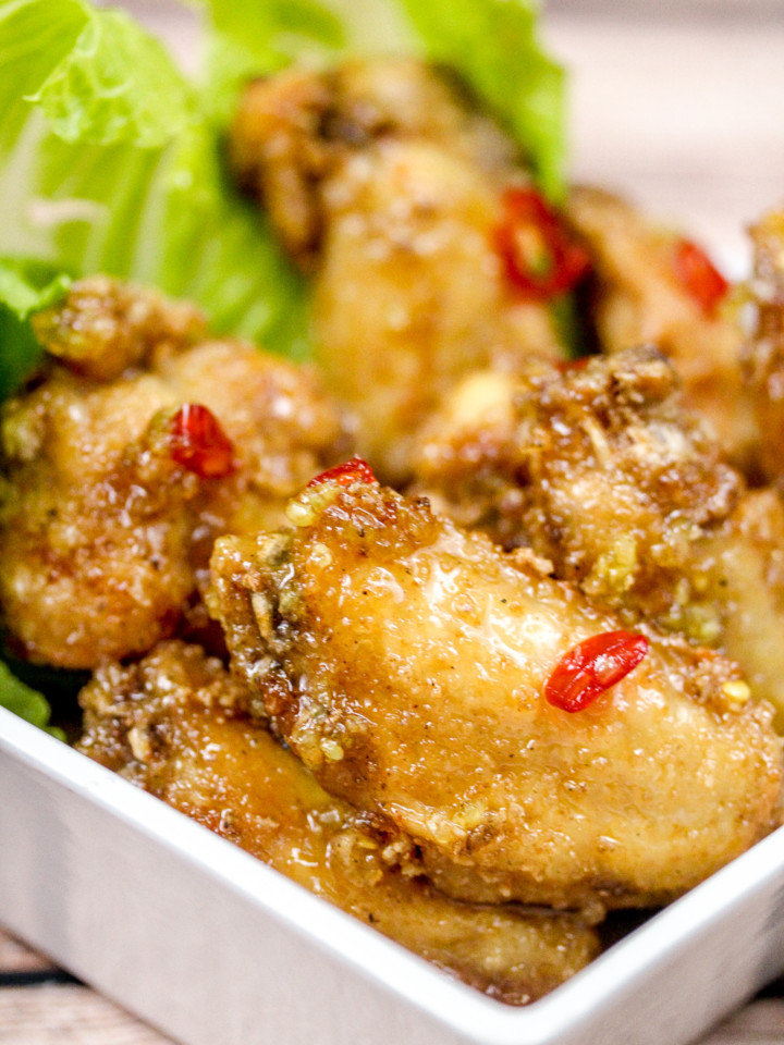 Chicken wings in a bowl with romaine lettuce