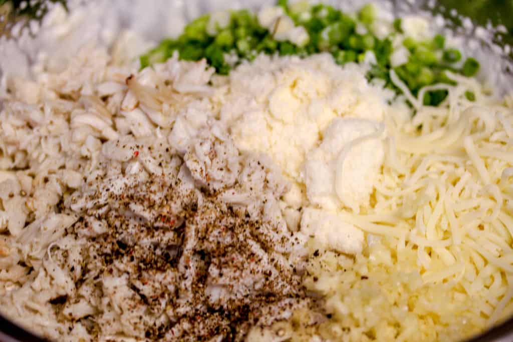 ingredients for crab rangoon dip in a metal bowl