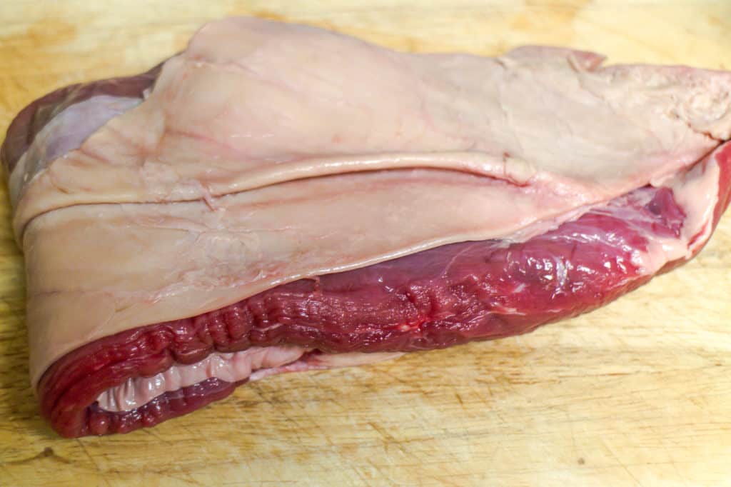 Slab of beef rough flank on a wooden board