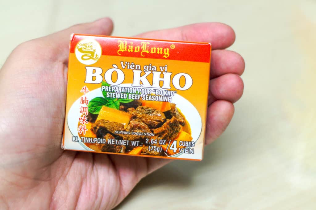 hand holding rectangular bouillon bos that says bo kho