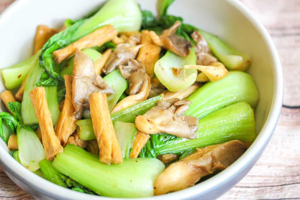 blue and white boy with oyster mushrooms, bok choy and tofu skin inside