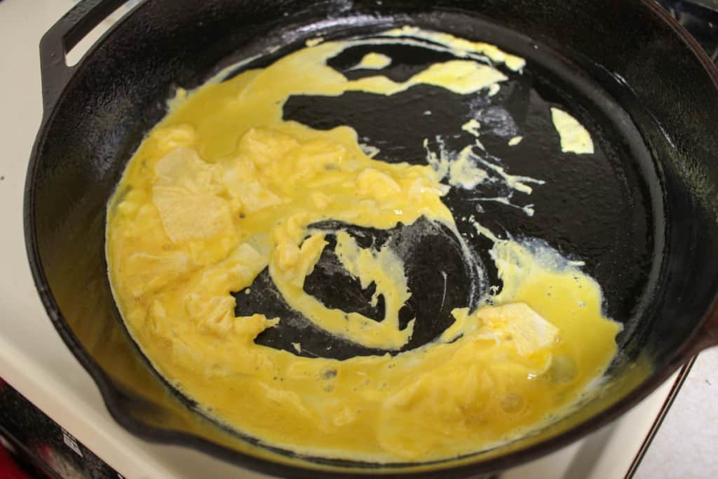 scrambled eggs in a cast iron skillet