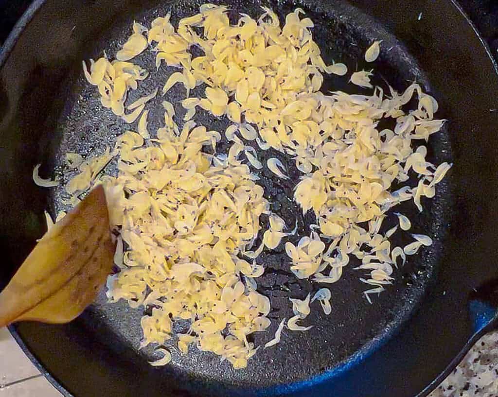 a cast iron pan with some tiny dried shrimp in it