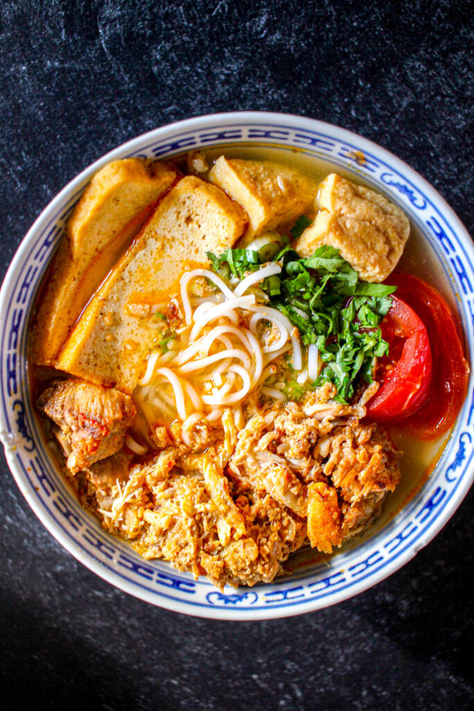 a birds eye view of a bowl of bun rieu with no chopsticks