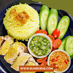 Hainanese chicken rice, Cơm Gà Hải Nam, is a dish of fragrant poached chicken and a rich, fatty rice cooked in chicken fat and broth.