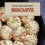 A photo of cooked spam and scallion biscuits in a cast iron skillet with a title on top of it that says "spam and scallion biscuits."