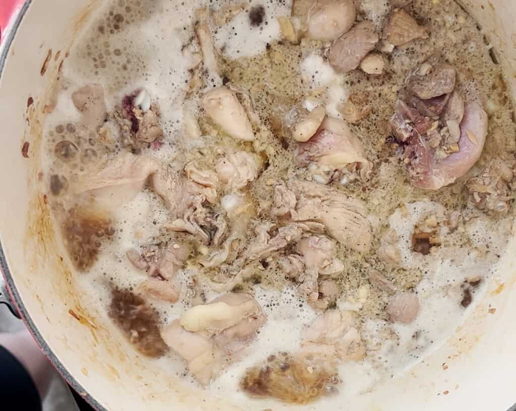 chicken braising in coconut water