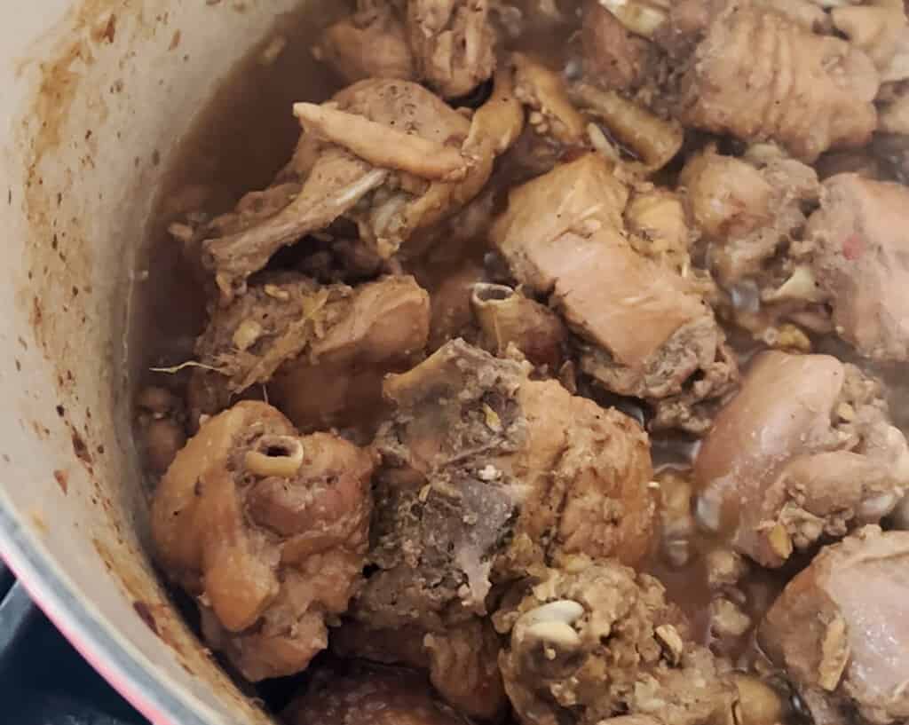 A close up of cooked ginger-braised chicken in a pot