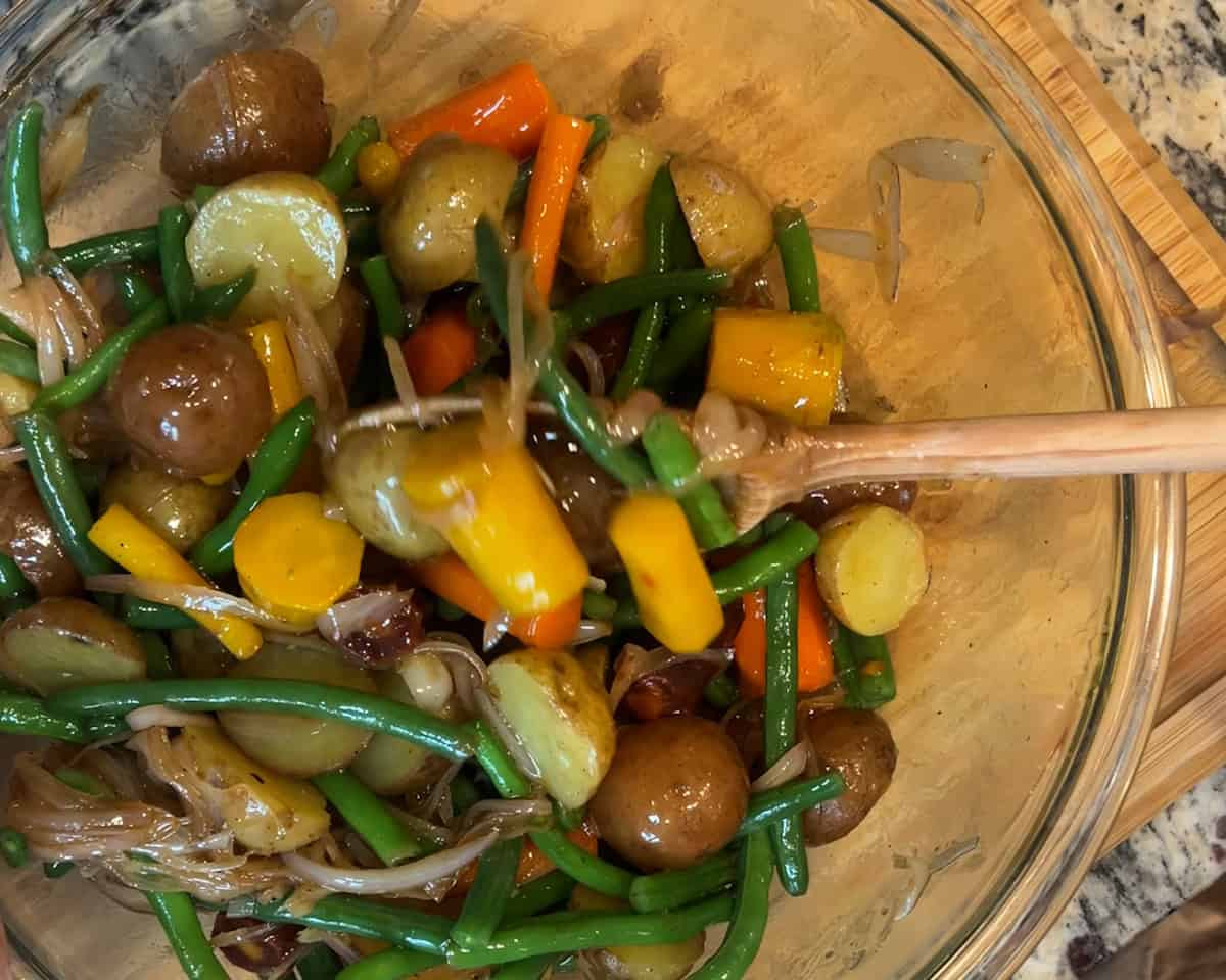 A glass bowl full of Vietnamese Potato Salad