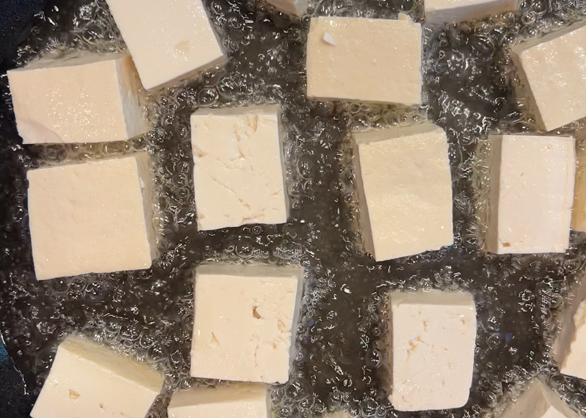 chunks of tofu sizzling in oil